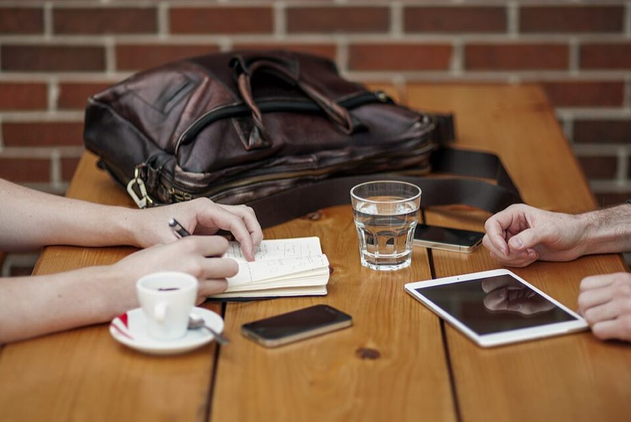 Two people reviewing notes across a table